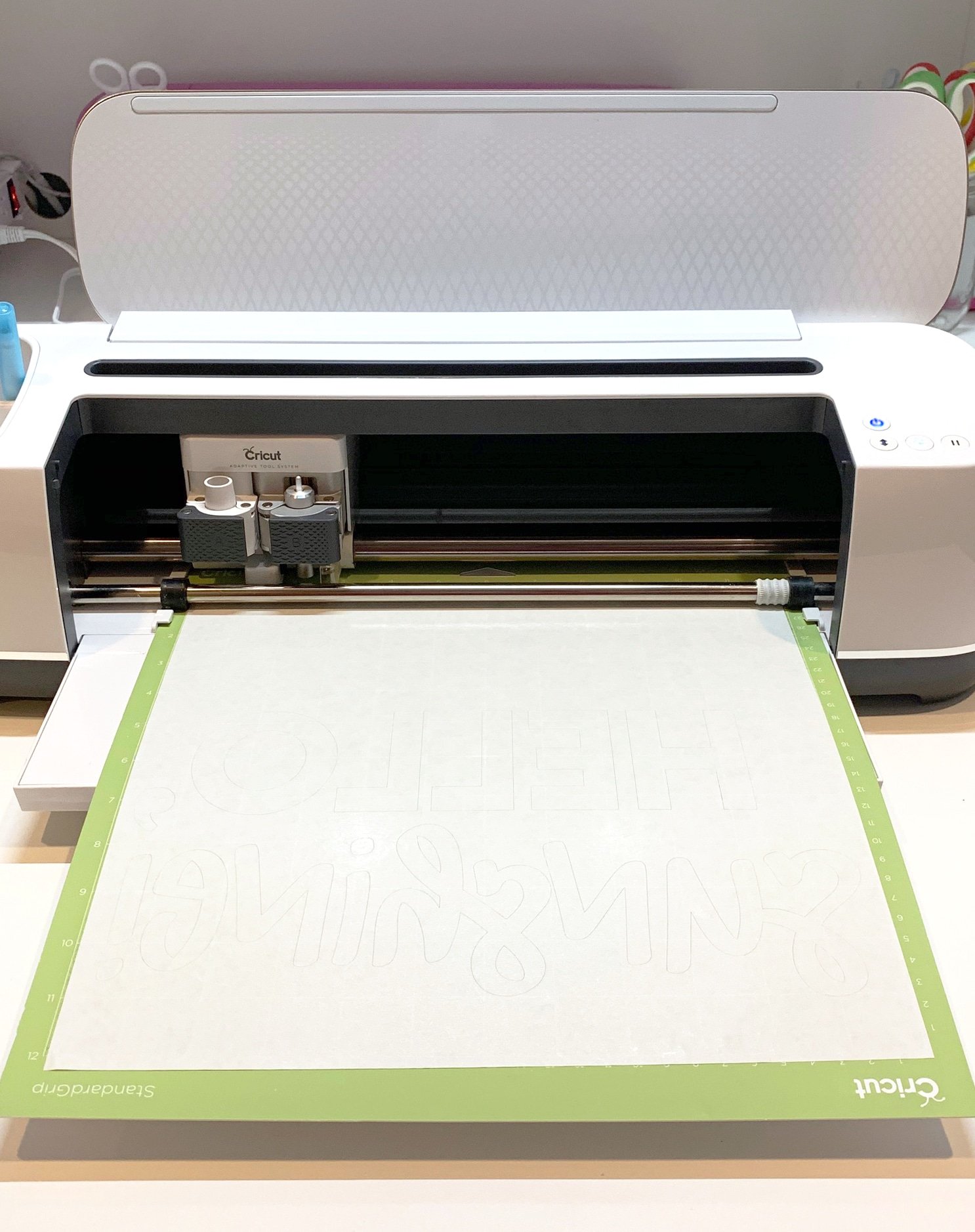cricut with material loaded onto mat