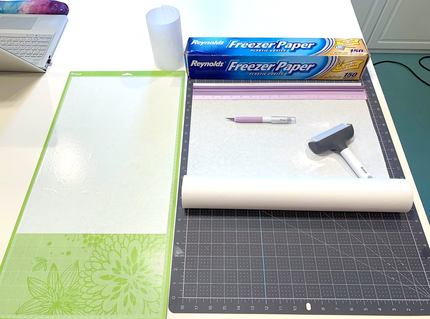 cutting freezer paper to size with various tools and cutting mat