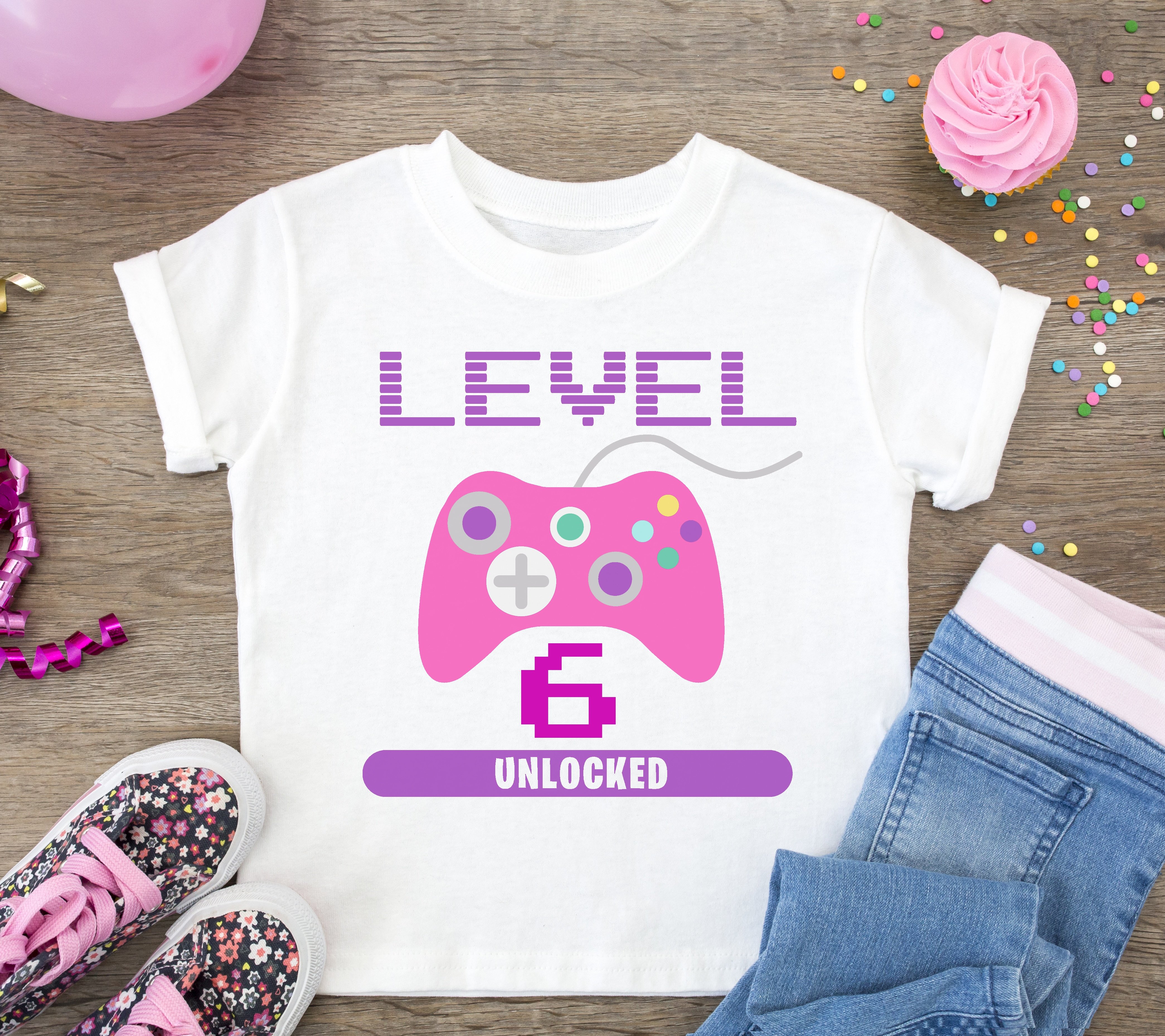 level 6 pink gamer controller svg file on white shirt with accessories