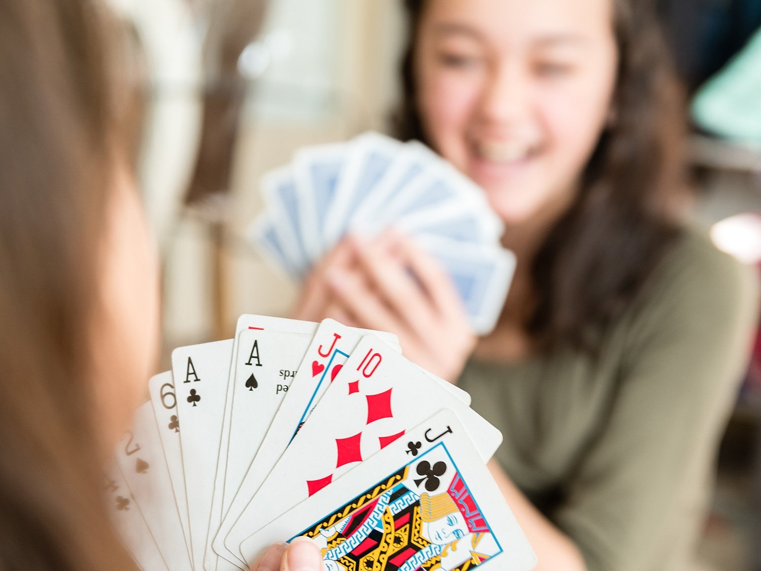 smiling kids holding cards