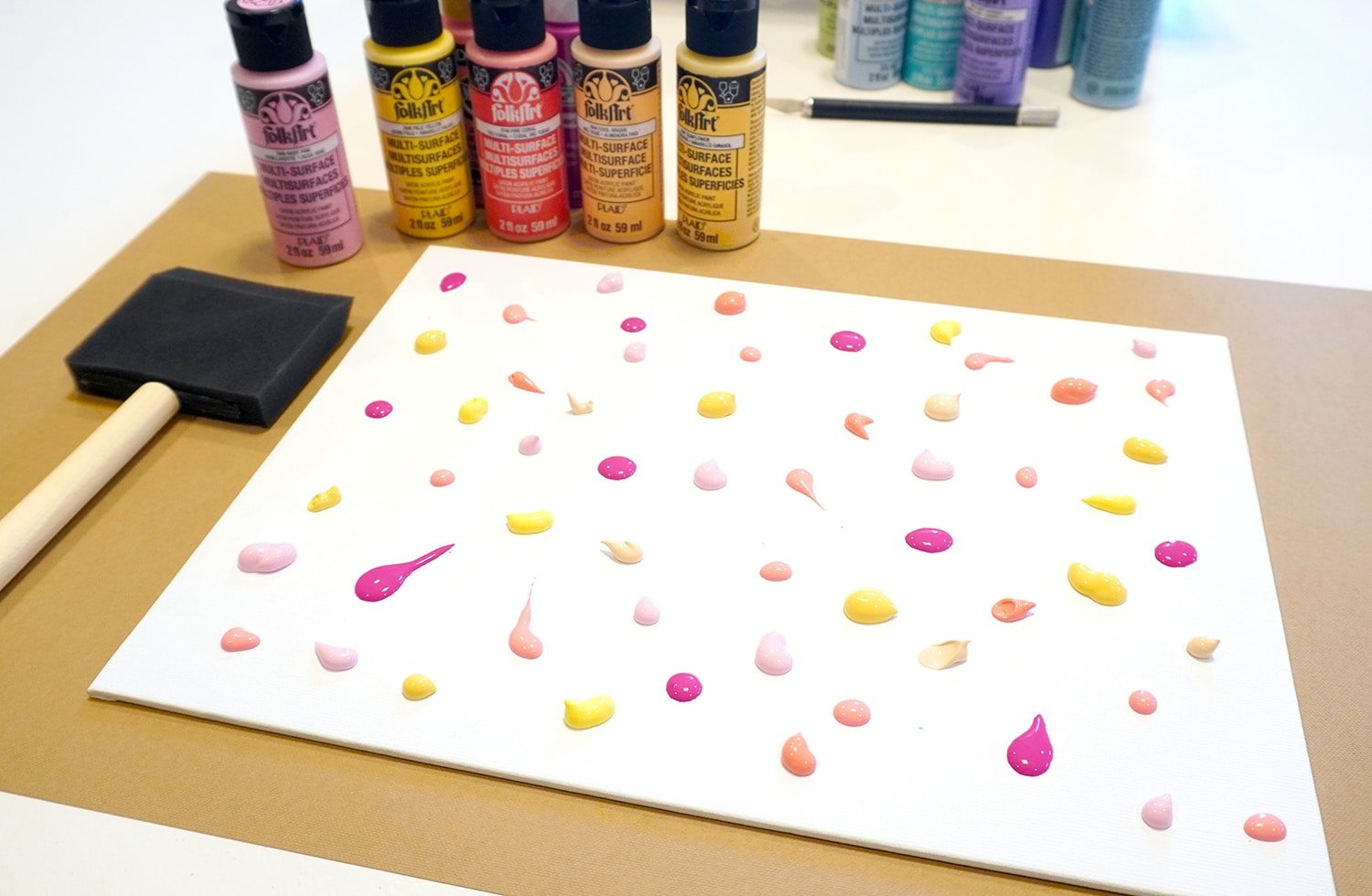 Colorful acrylic paint drops and blobs on canvas