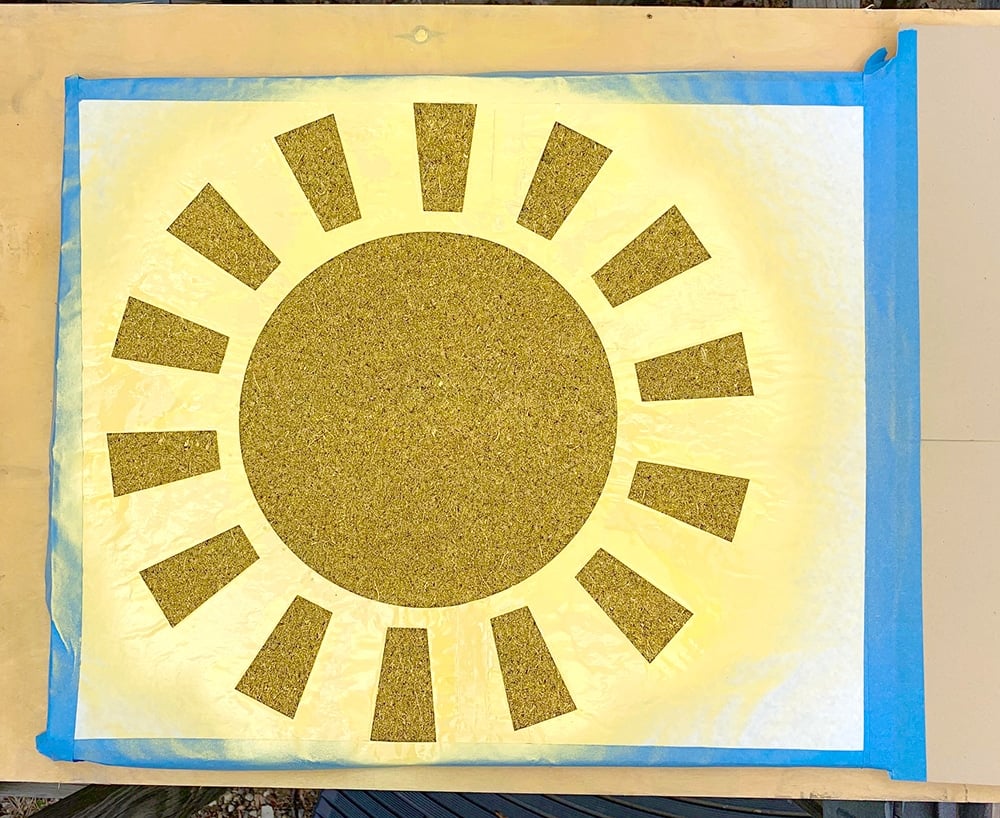 sunshine stencil with spray of yellow paint