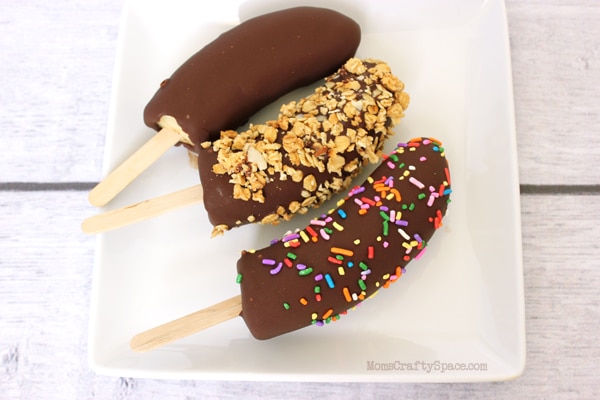 chocolate covered banana pops with assorted toppings