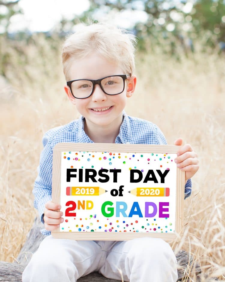 boy holding printable first day of school sign