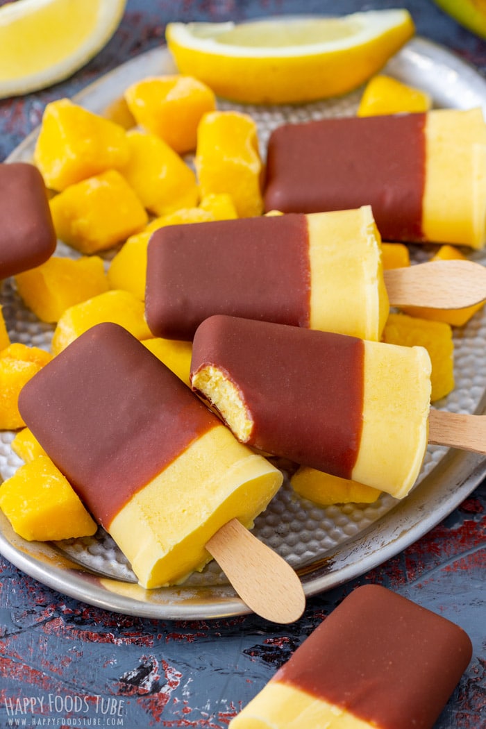 mango yogurt popsicles with chunks of mango 