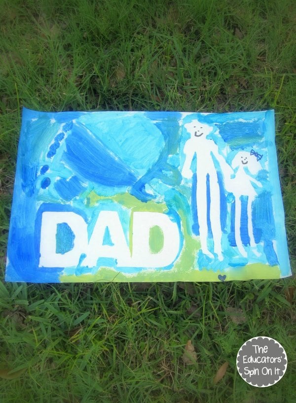painted canvas with the word dad and image of two people