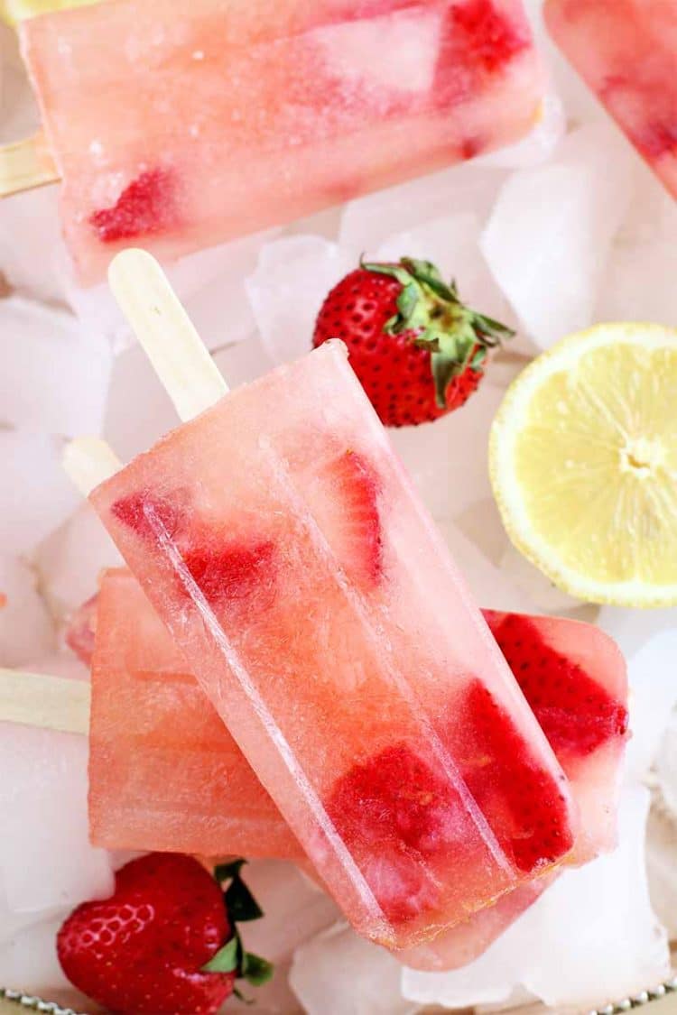 strawberry lemonade popsicles with fresh strawberries and sliced lemon