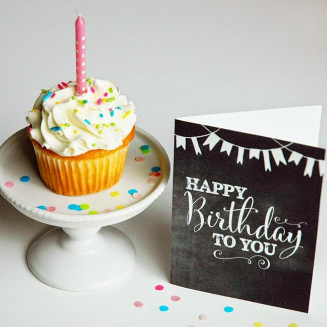 happy birthday printable card next to a birthday cupcake on a platter