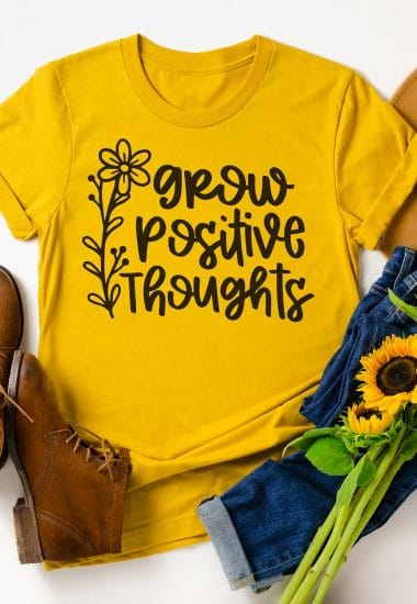 Yellow t-shirt with grow positive thoughts graphic with brown shoes and sunflowers