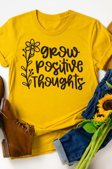 Yellow t-shirt with grow positive thoughts graphic with brown shoes and sunflowers