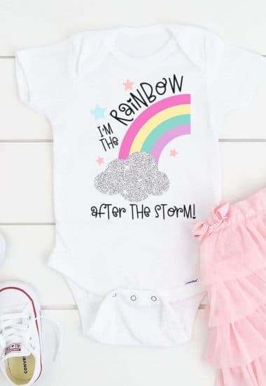 Baby bodysuit with "I'm the Rainbow After the Storm" design surrounded by a pink tutu and white shoes