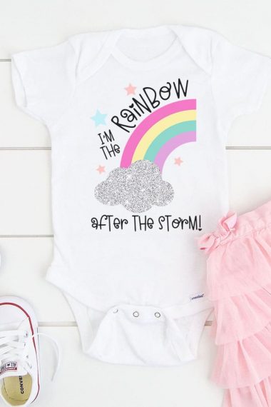 Baby bodysuit with "I'm the Rainbow After the Storm" design surrounded by a pink tutu and white shoes