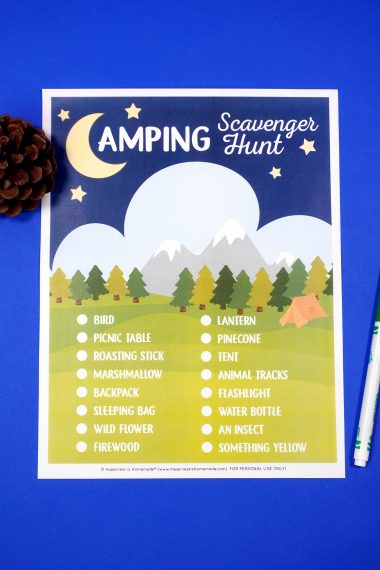 Printable Camping Scavenger Hunt game on blue background with pinecone and green pen