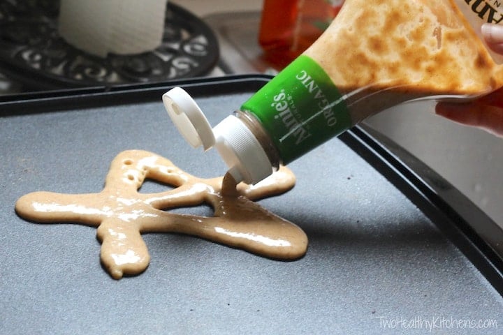 Ketchup bottle filled with pancake batter making a star shaped pancake.