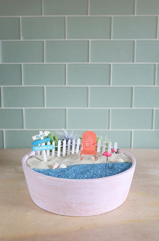 Fairy garden in a bowl with miniature adirondack chair and flamingo