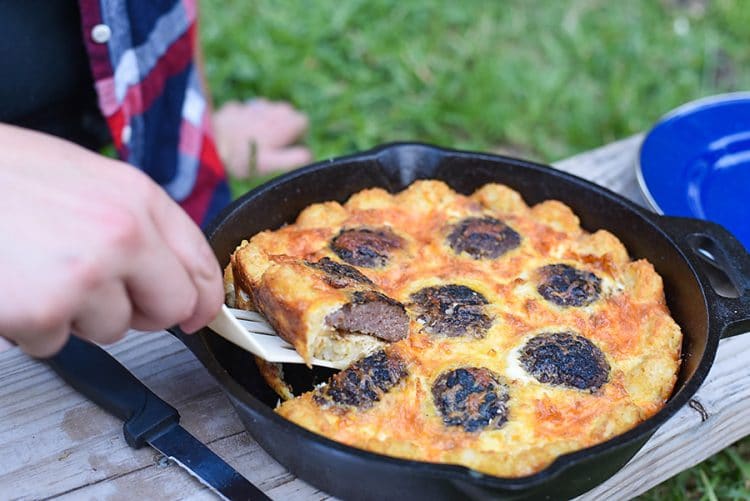 spatula removing piece of campfire breakfast pizza