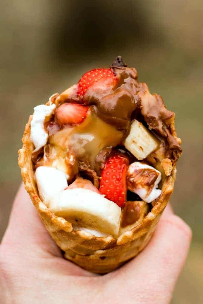 campfire waffle cones filled with chocolate, bananas, and strawberries