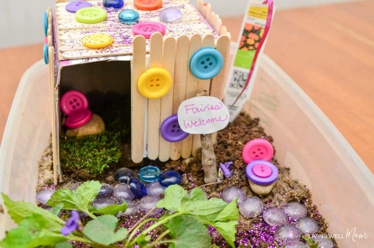 Fairy garden door made of popsicle sticks and decorated with colorful buttons