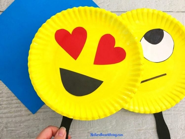 emoji paper plate craft on sticks being held