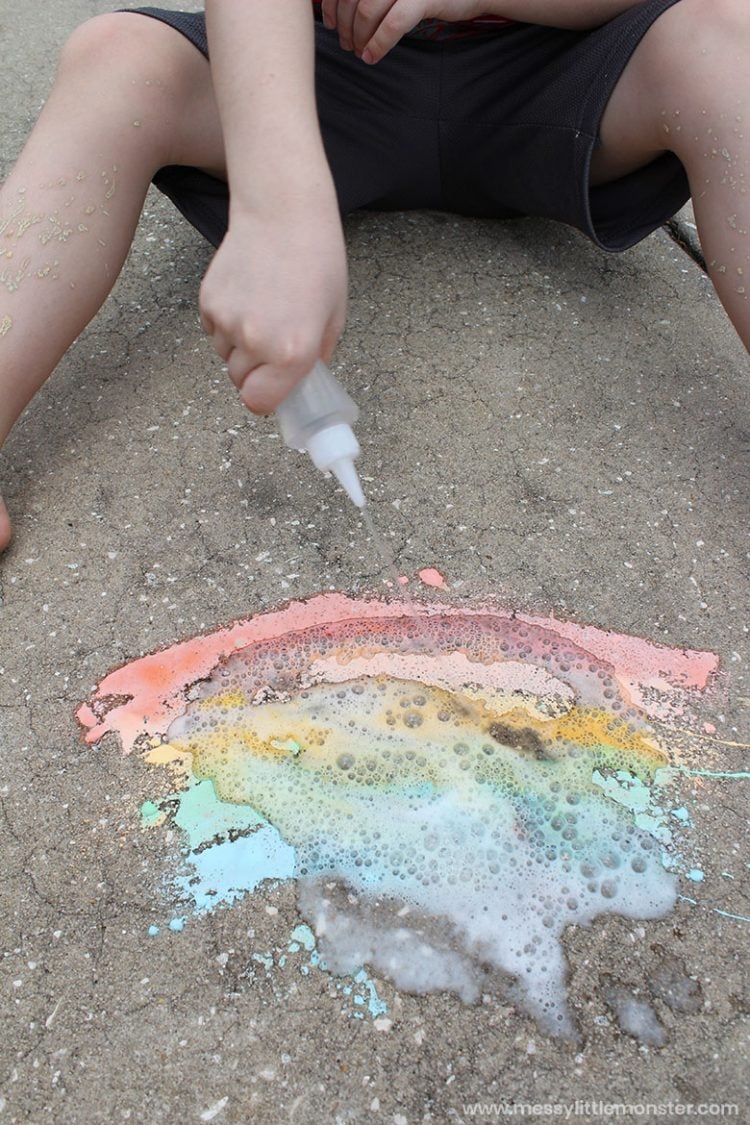 Child playing with fizzy sidewalk paint 