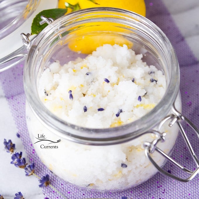 Jar of lemon lavender coconut sugar scrub with lavender buds and lemon 