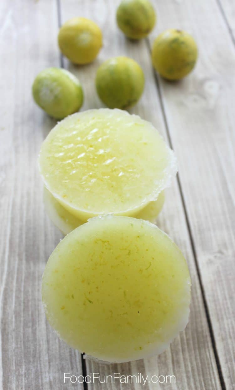 Lime and coconut sugar scrub bars on a wood background with limes