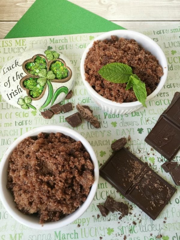 Two bowls of mint chocolate sugar scrub with mint leaves and chocolate bar pieces 