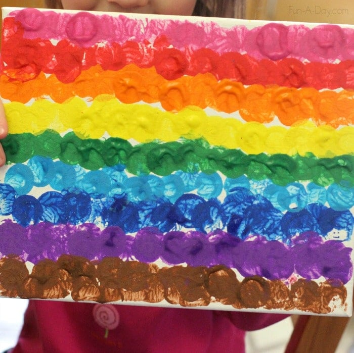 Rainbow kids painting made from stamping wine corks on canvas 