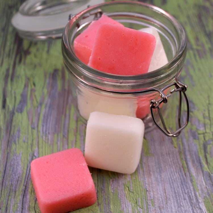 Glass jar with red and white peppermint sugar scrub bars