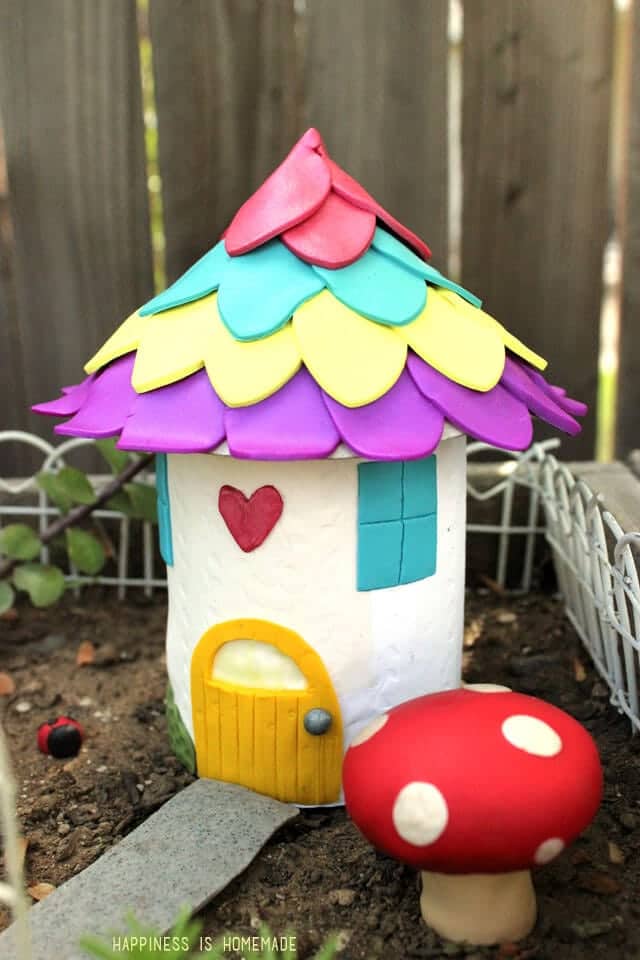 Colorful fairy garden house made from recycled can and polymer clay