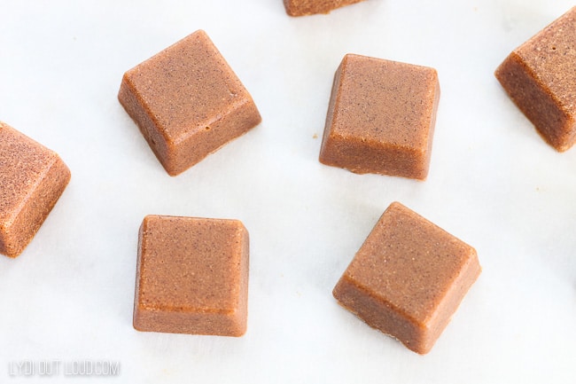 four pumpkin spice sugar scrub cubes on white background