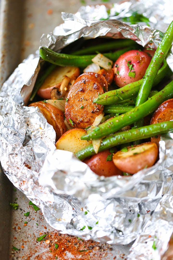 foil wrapped around sausage potatoes and green beans 