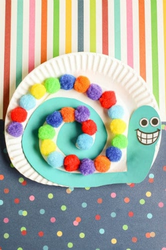 colorful snail made from pom poms and paper plate