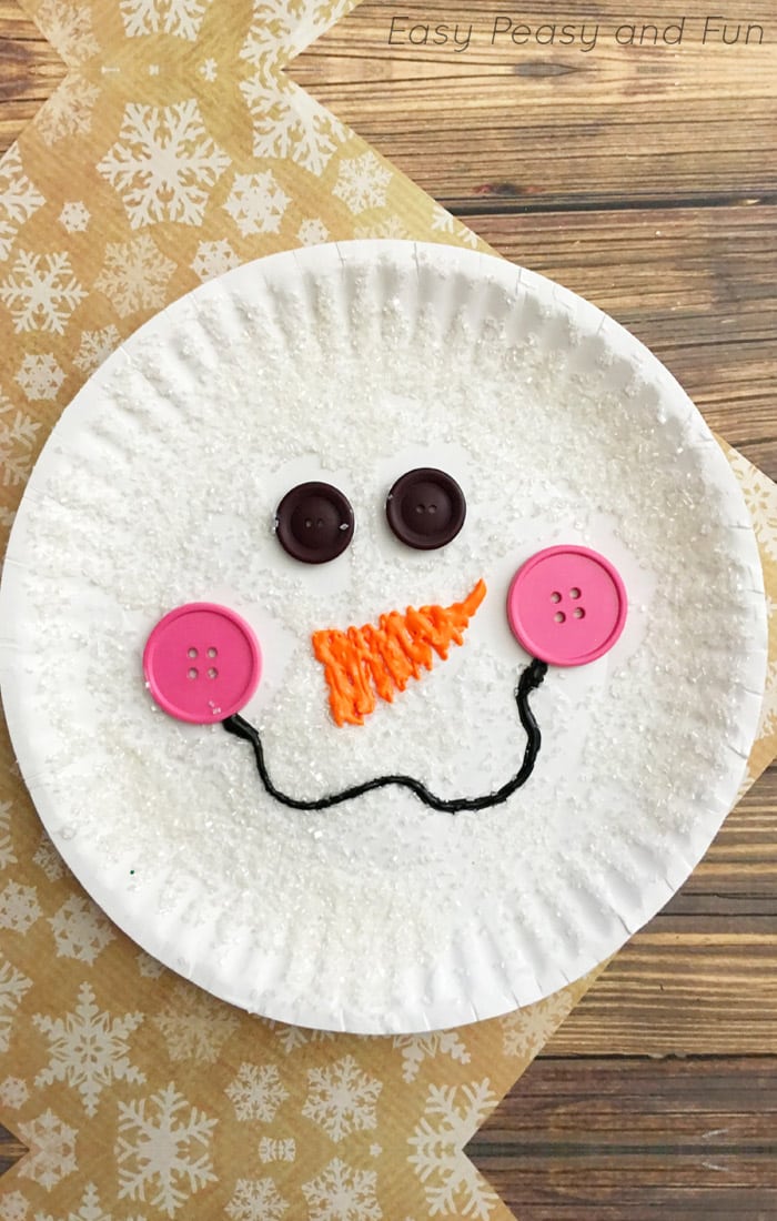 smiling snowman face on paper plate