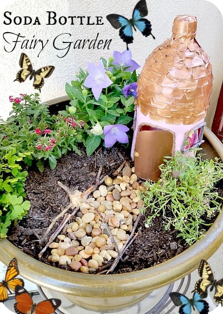 Fairy garden with fairy house made out of a recycled soda bottle
