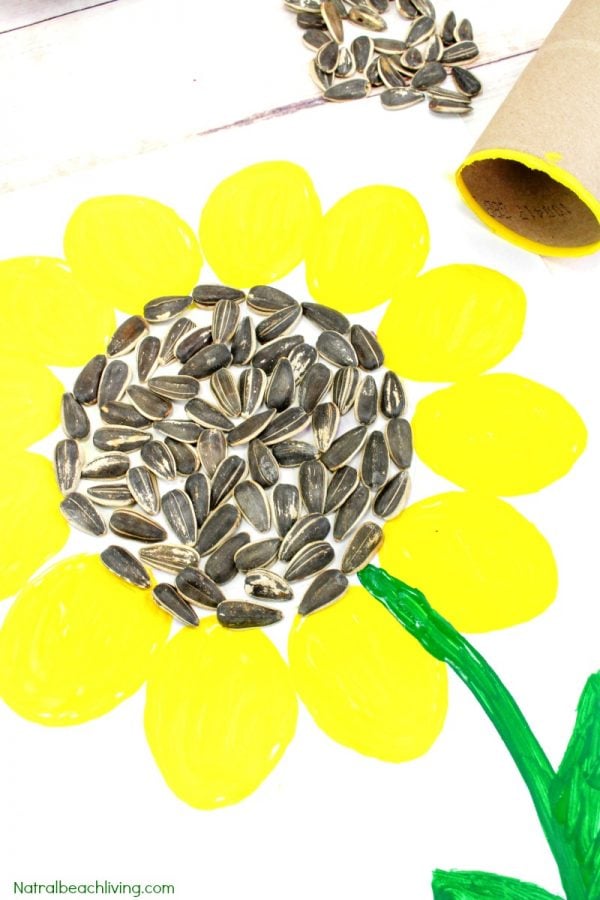 Picture of a painted sunflower with real sunflower seeds in the middle of the flower 