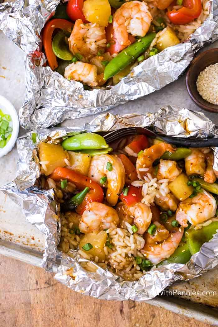 teriyaki shrimp wrapped in foil packets with toppings