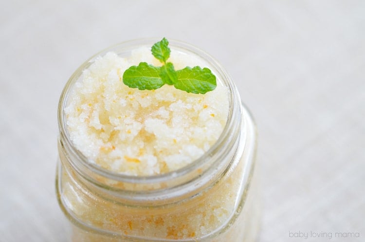 close up of jar of vanilla orange mint sugar scrub with mint leaves on top