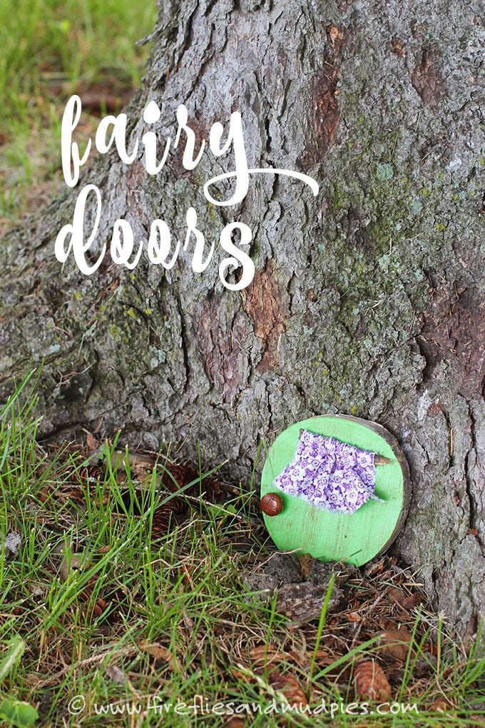 Fairy garden door made from round piece of wood painted mint green with purple flower printed cloth window covering
