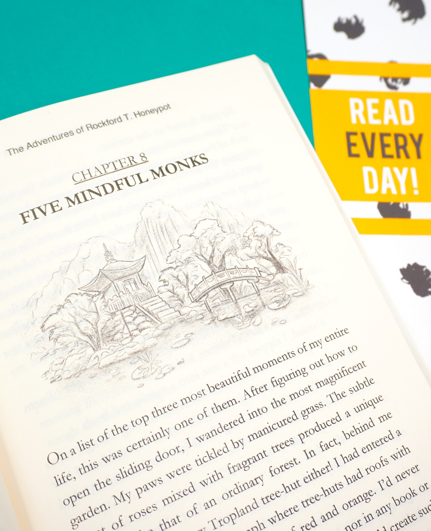 A close up of book page and a \"Read Every Day\" printable bookmark