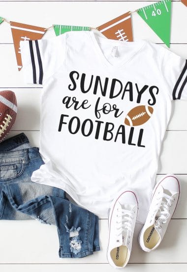 "Sundays are for Football" Shirt on white wood background with football, jeans, white shoes, and football banner