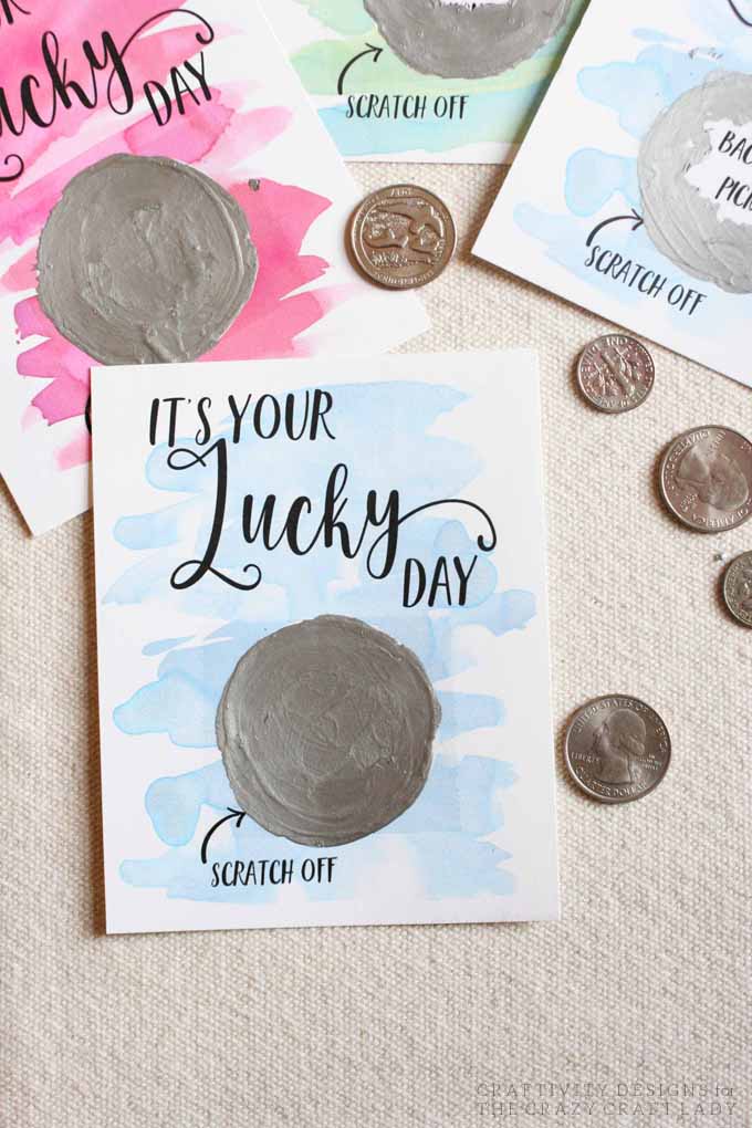 Coins pictured laying next to scratch off cards 