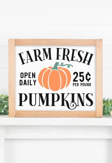 "Farm Fresh Pumpkins" sign with wood frame on white mantel