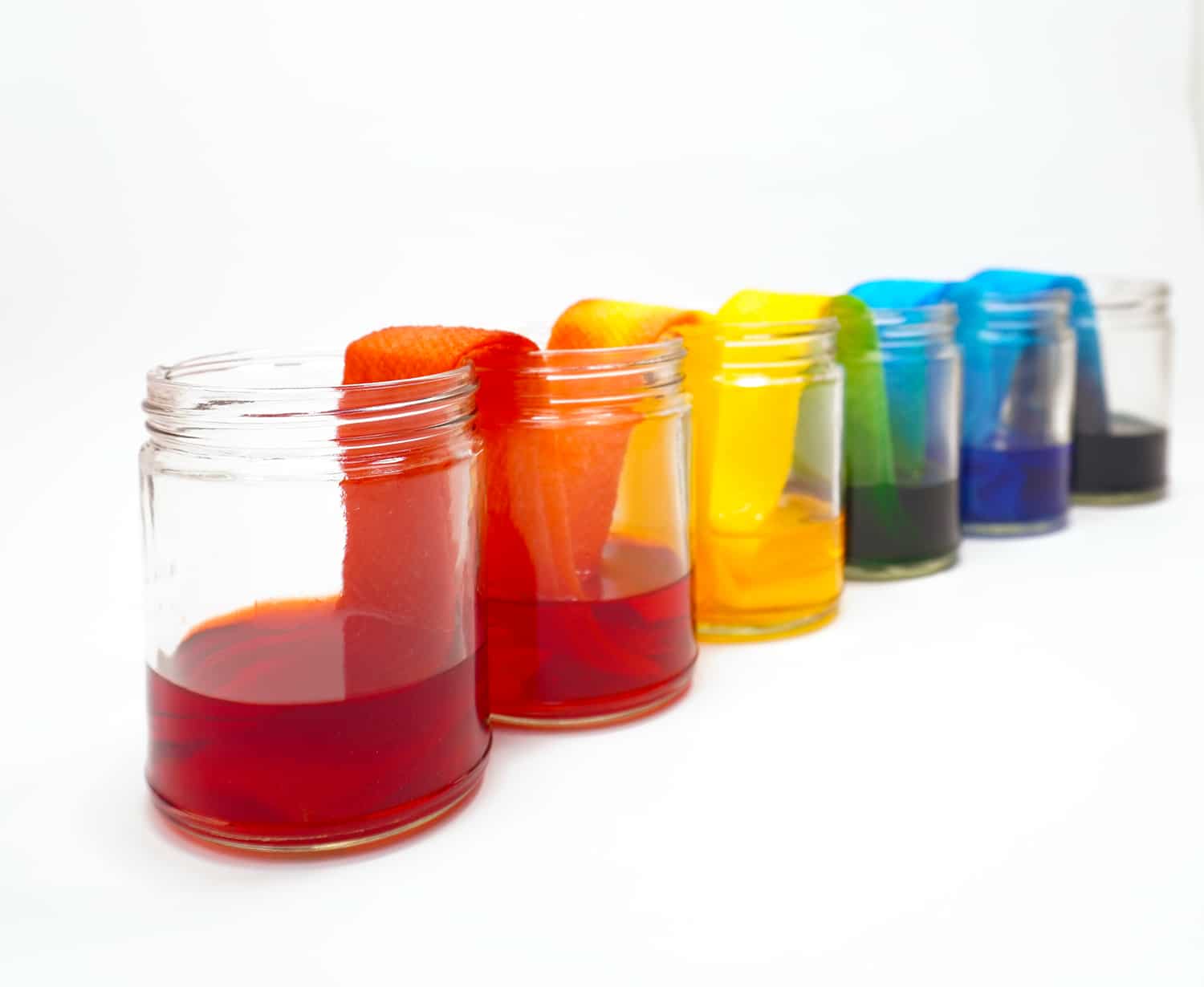 walking rainbow stem activity jars lined out in a straight line
