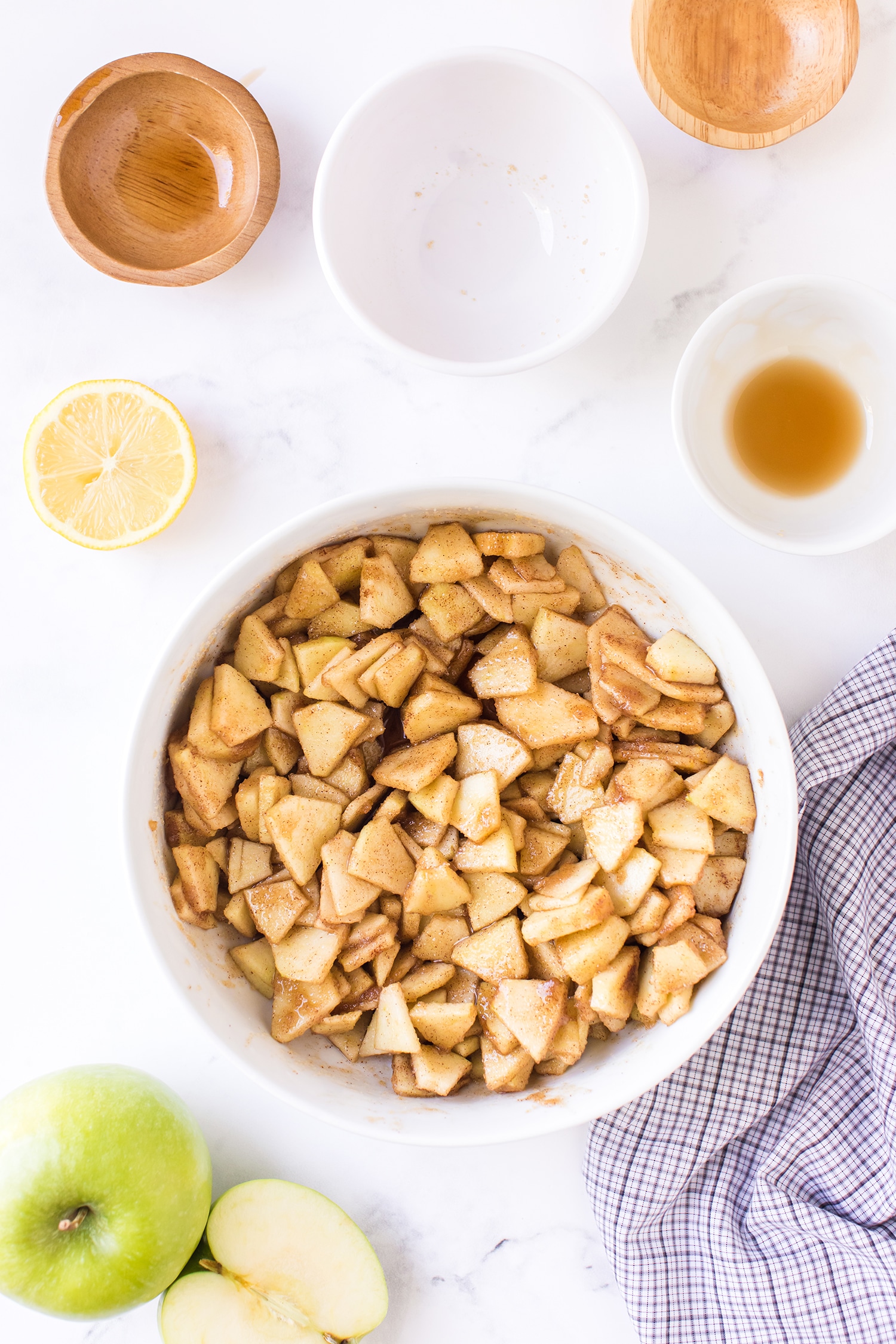 Apple Pie Bar Filling Ingredients in Bowl on white marble background