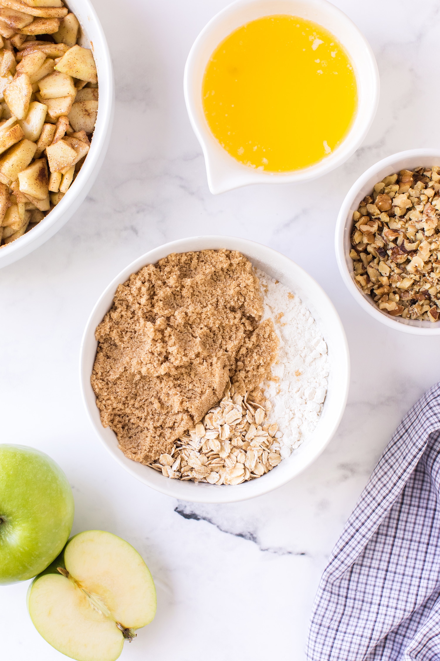 Apple Pie Bar Streusel Topping Ingredients in Bowl with apples and melted butter on the side