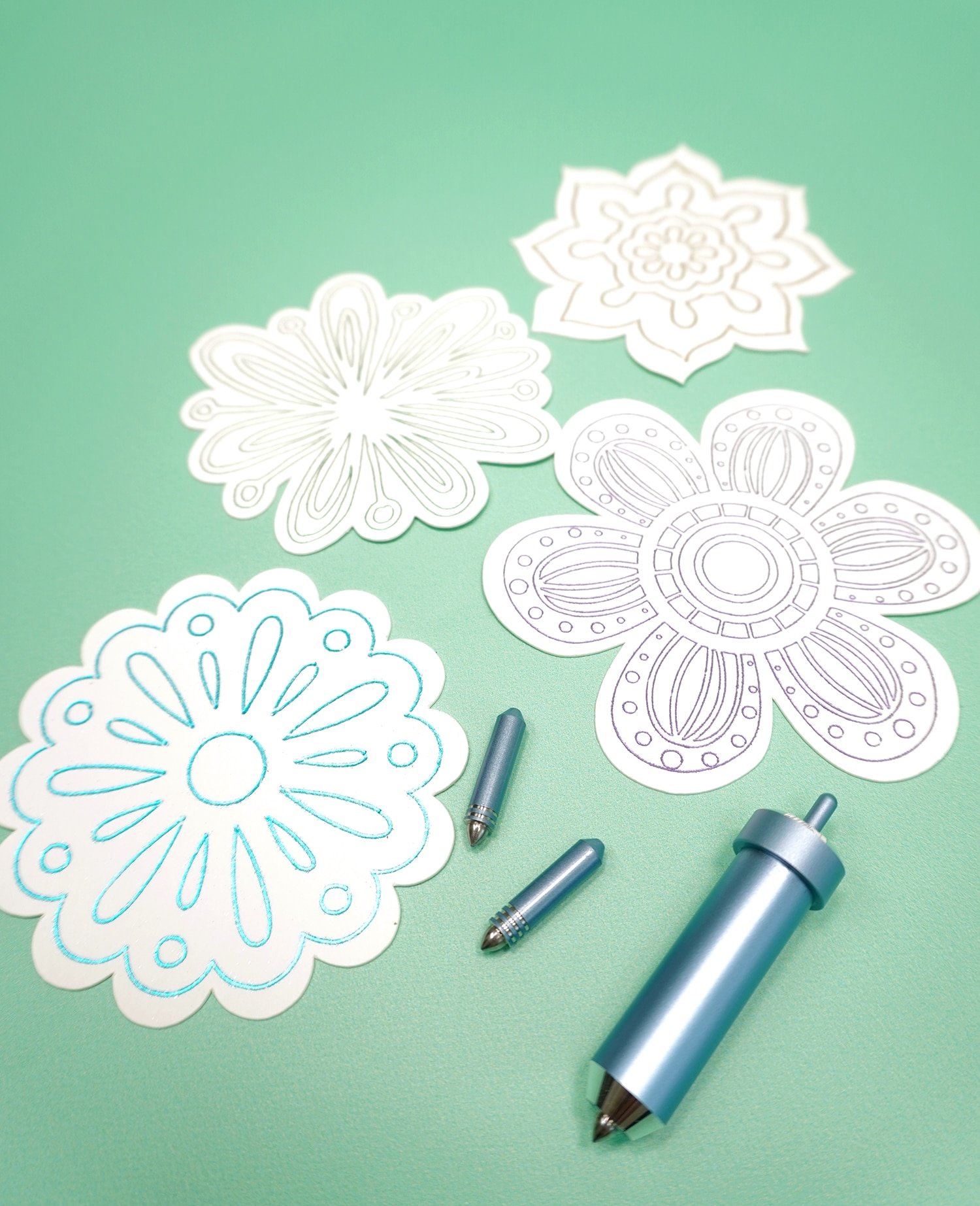 Cricut Foil Transfer Tools and Tips with white foil embellished flower die cuts on mint green background