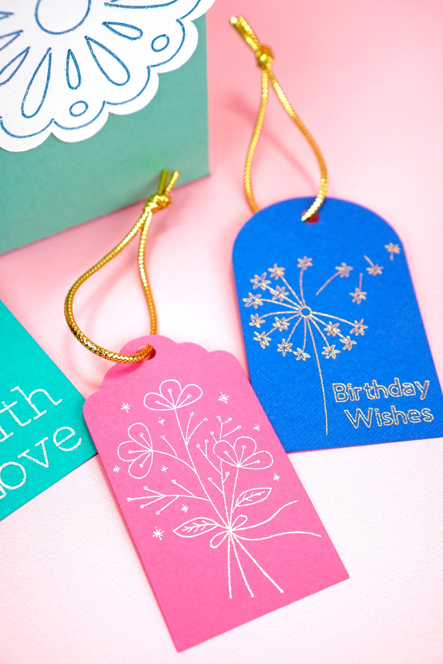 pink and blue foil embellished gift tags on coral background