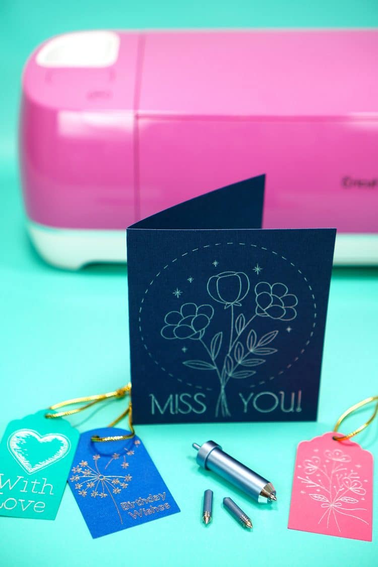 Colorful cards and gift tags with Cricut Foil Transfer System Tools and pink Explore Air 2 on teal background