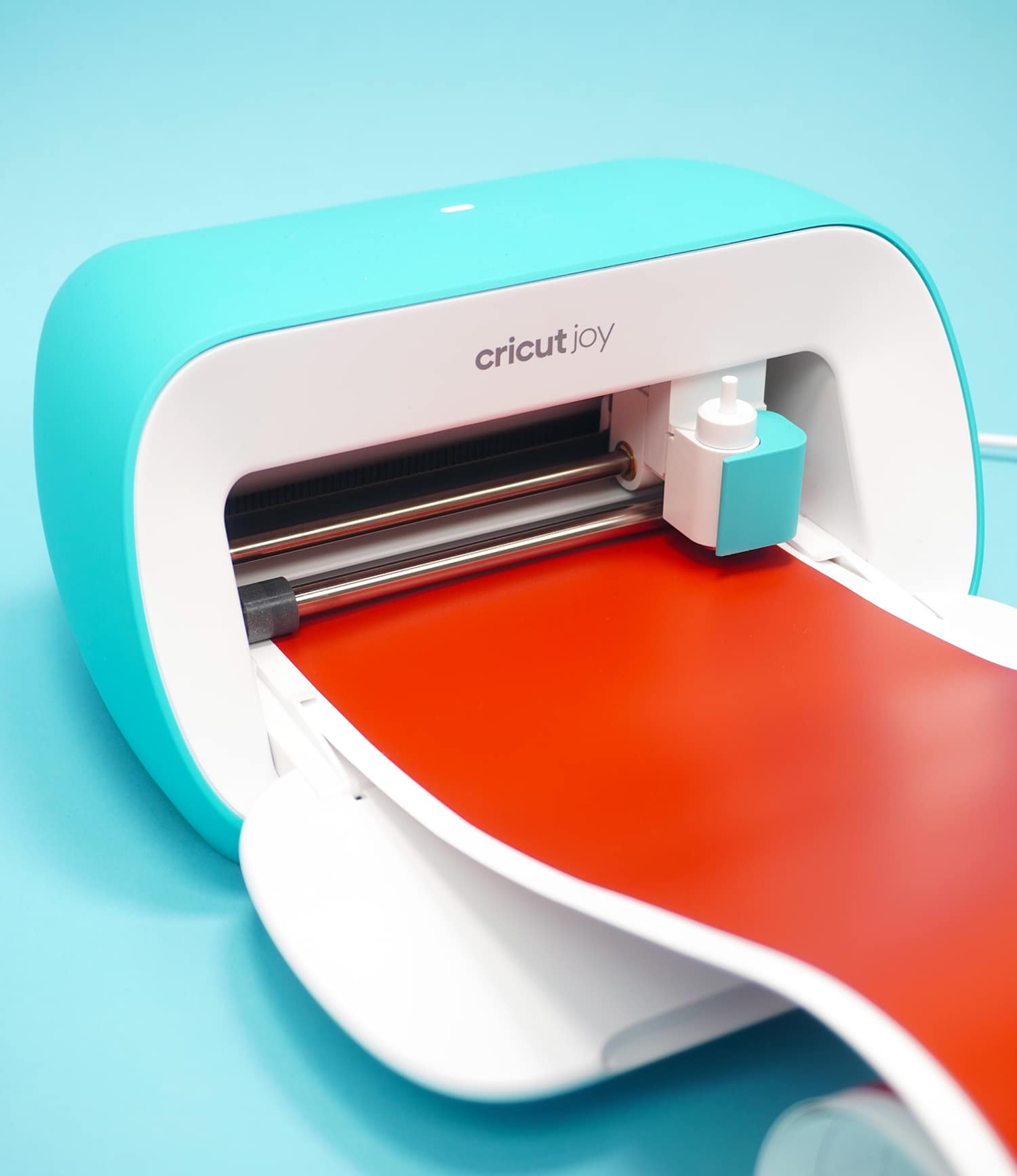 Cricut Joy machine loaded with red Smart Vinyl